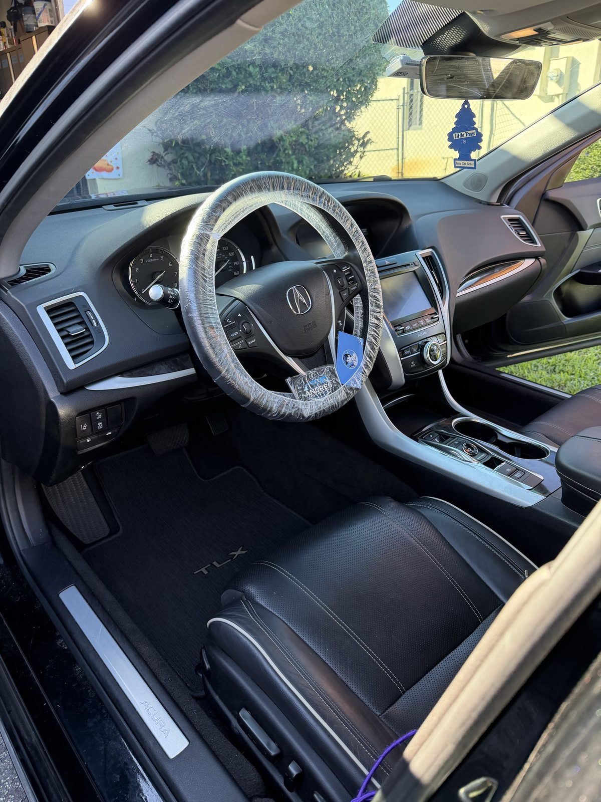 Acura TLX interior after detailing, steering wheel covered during service